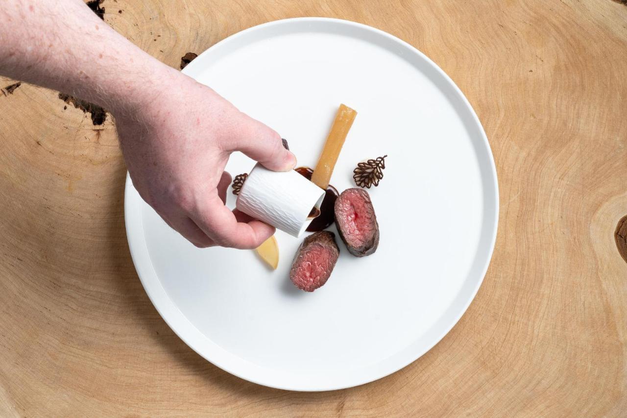 Boringdon Hall Hotel And Spa Plymouth Exterior foto A hand seasoning a plate of food with a spice shaker